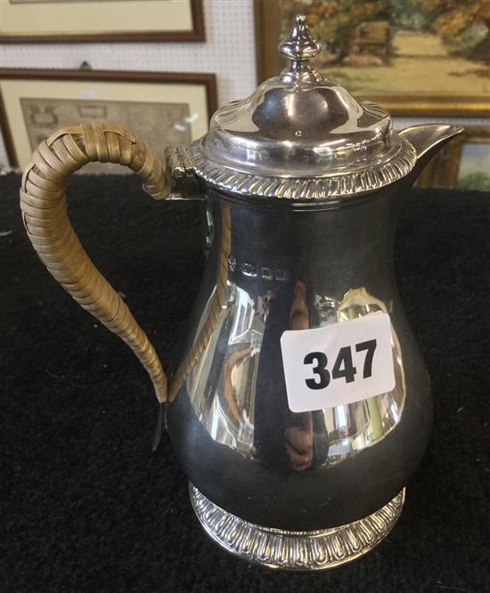 Silver jug with wicker handle